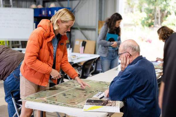 Hannah showing a property map to one of the landholders